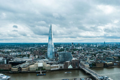 View of cityscape against cloudy sky