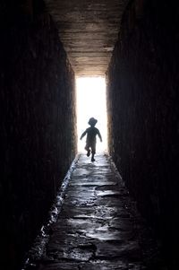 Woman walking in tunnel