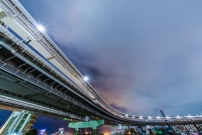 Low angle view of illuminated bridge against sky at night