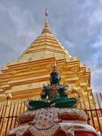 Low angle view of statue against temple building