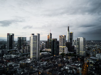 View of cityscape against cloudy sky