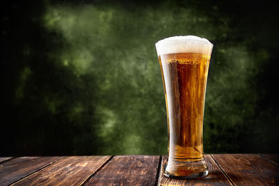 Close-up of beer glass on table