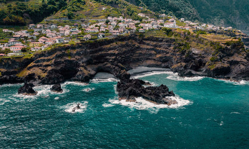 City seixal, atlantic ocean coastline. empty beach, sea waves. madeira, portugal. drone photography