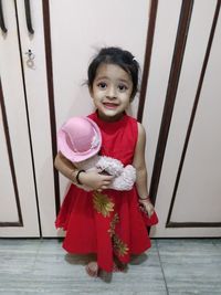 Portrait of cute girl smiling on floor at home