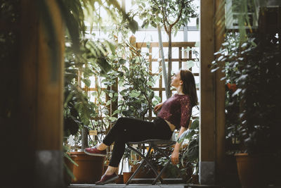 Man sitting on chair by window