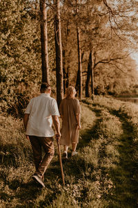 Rear view of man walking in forest