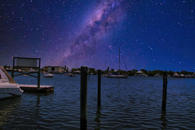 Scenic view of lake against sky at night