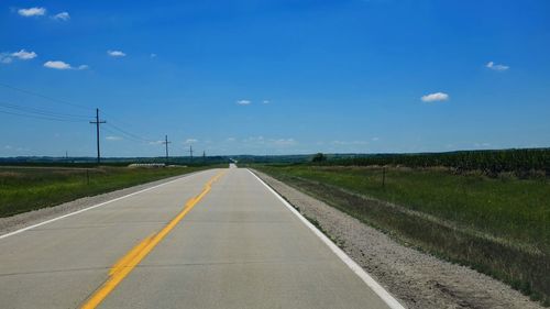 Road by landscape against sky