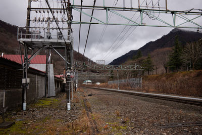Railroad tracks by buildings against sky