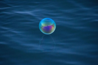 Close-up of bubbles floating on water