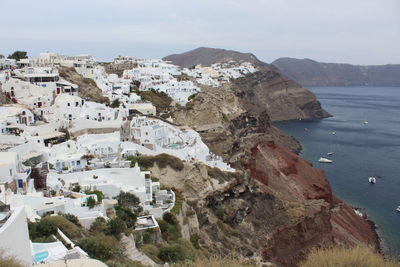 Scenic view of sea and townscape against sky