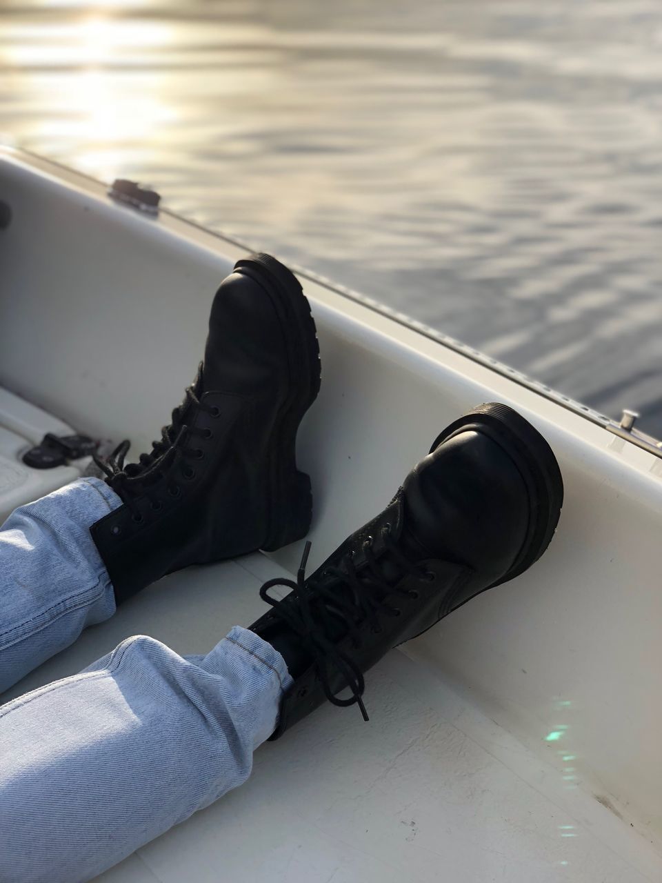 LOW SECTION OF SHOES ON BOAT
