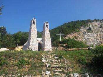 Low angle view of old ruin against clear blue sky