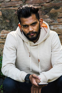 Portrait of young man sitting outdoors