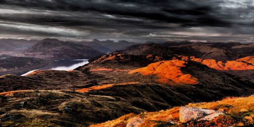 Scenic view of mountains against cloudy sky