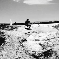 Full length of man on boat in sea against sky