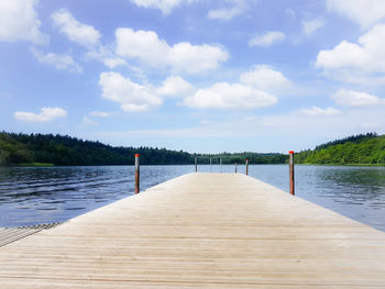 Pier over lake against sky