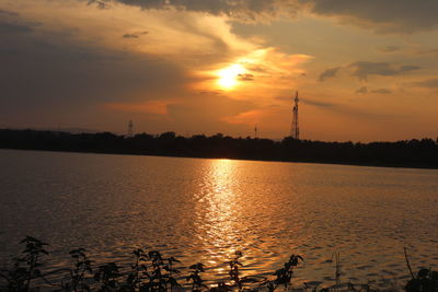 Scenic view of lake against sky during sunset