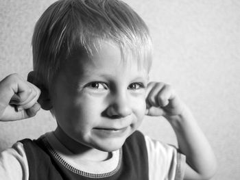 Portrait of cute boy against wall