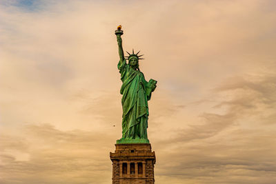 Low angle view of statue of liberty against sky during sunset