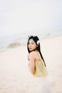 Portrait of woman standing at beach