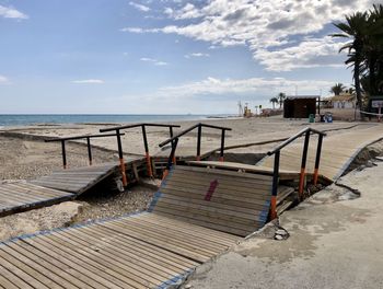 Destroyed wooden seafront promenade after heavy rains and storm campoamor beach march 8, 2021