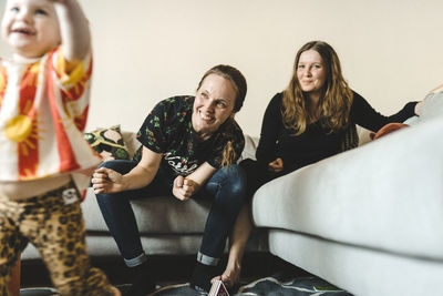 Women sitting on sofa at home