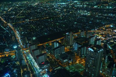 High angle view of city lit up at night