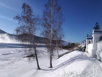 Snow covered landscape against sky