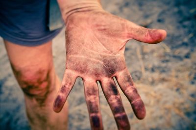 Midsection of person with dirty hand