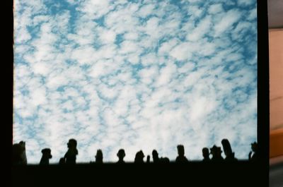 Silhouette people looking at sky