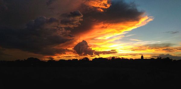 Silhouette of landscape against cloudy sky