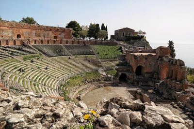 People at amphitheater against sky