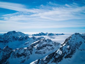 Scenic view of snowcapped mountains against sky