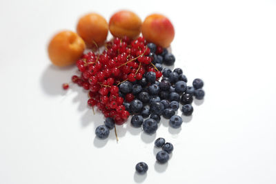 Close-up of red fruit over white background