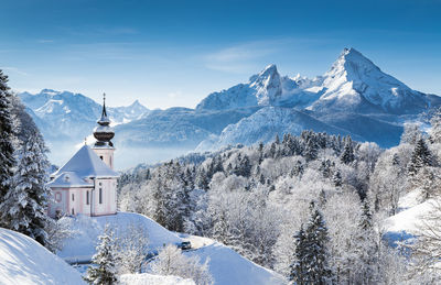Maria gern church on snowcapped mountains against sky