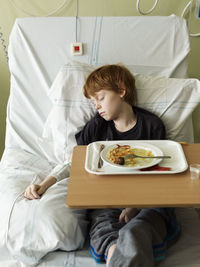 Boy napping on hospital bed