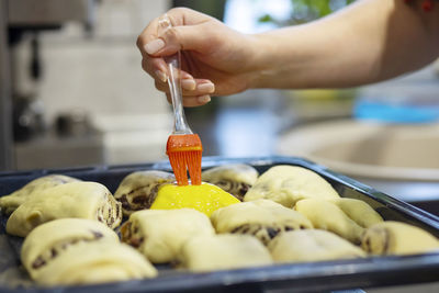 Cropped hand of man preparing food