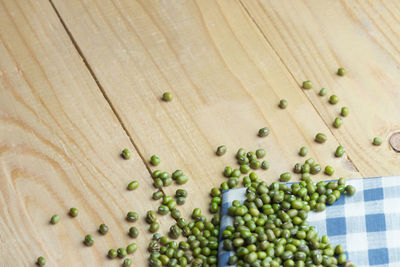 High angle view of beans on wooden table