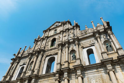 Low angle view of historical building against blue sky