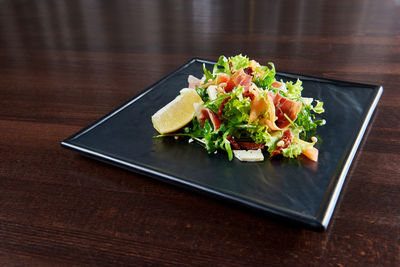 High angle view of fruits in plate on table