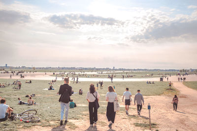 People at park against sky during sunny day