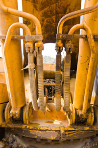 Close-up of yellow machine part in factory