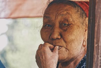 Close-up portrait of woman against blurred background