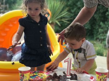 Baby boy touching cake