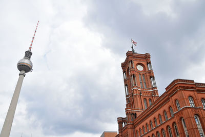 Low angle view of clock tower against cloudy sky