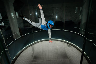 Low section of man jumping in water