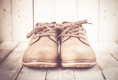 Close-up of shoes on wooden floor