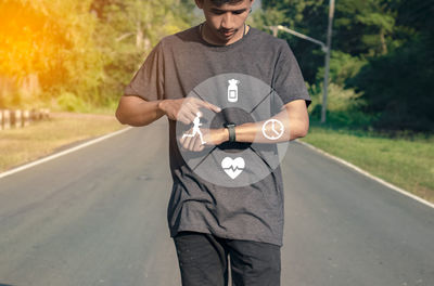 Midsection of man standing on road