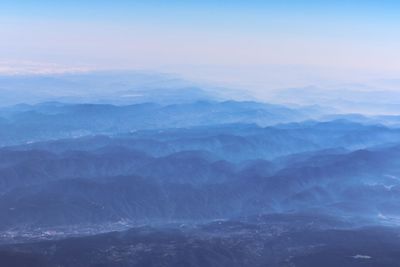 Aerial view of mountain range against sky